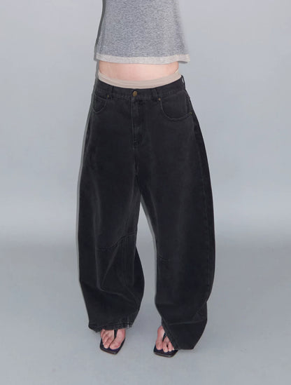 DISTRESSED CURVED-BLADE JEANS