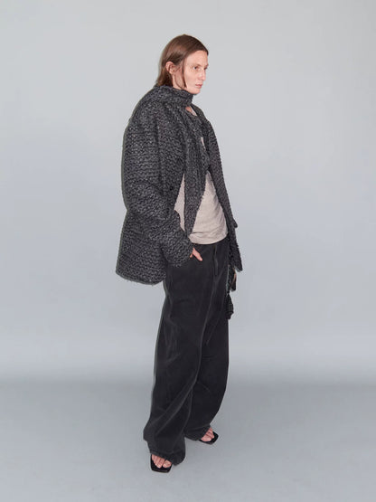 DISTRESSED CURVED-BLADE JEANS