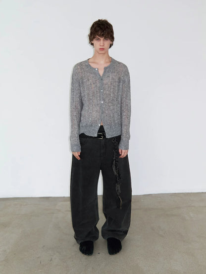 DISTRESSED CURVED-BLADE JEANS